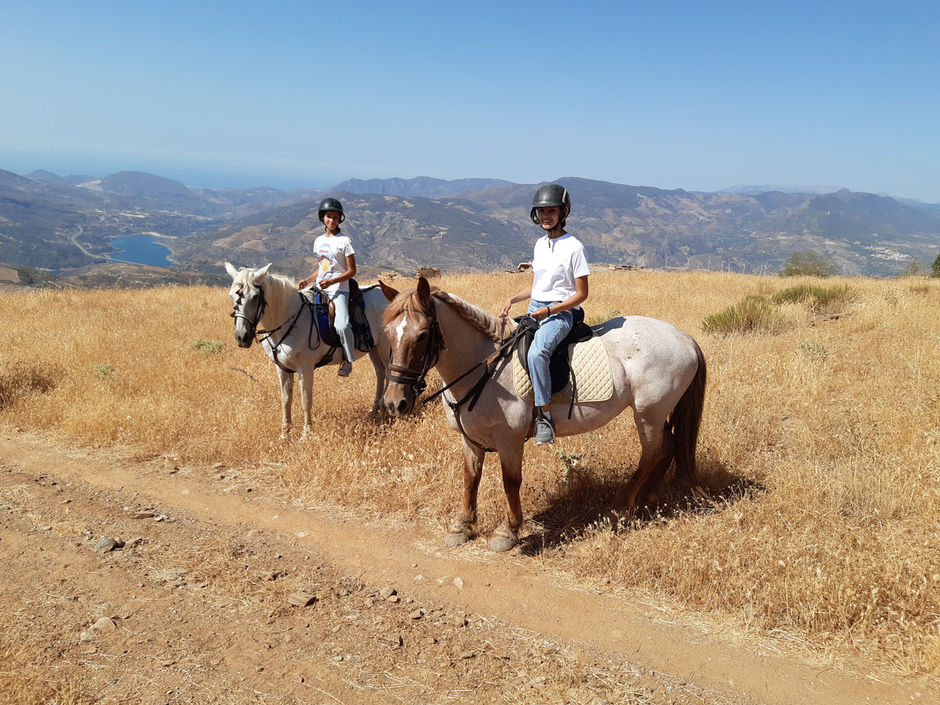 Two girls riding horses in Spain