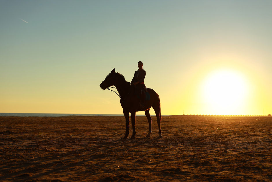 A man riding a horse at sunset, Barcelona