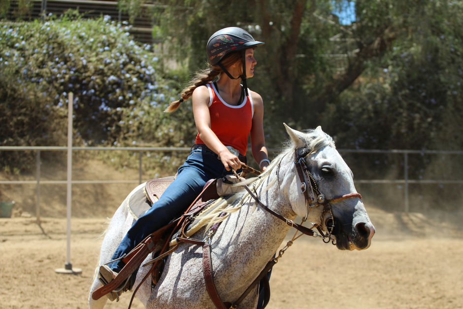 А girl in equestrian training